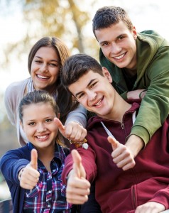 Group of a few students happy and giving a thumbs up